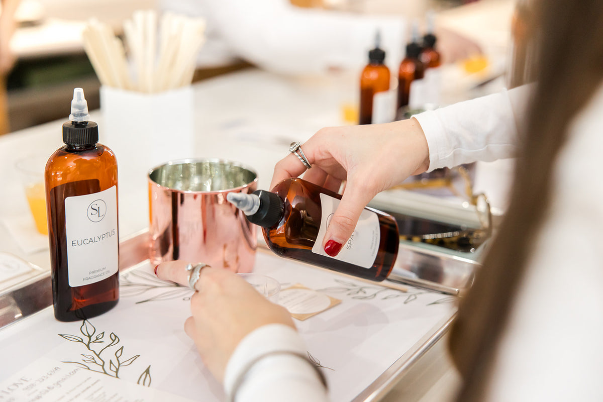 Wall of fragrance oils for blending your own candle scent